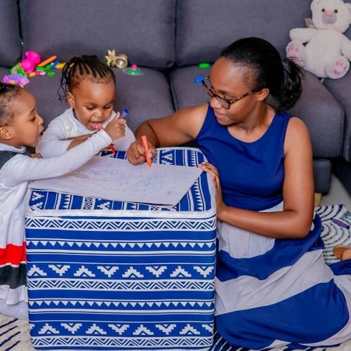 A Mother Drawing with her Children on a MoKo Pouffe