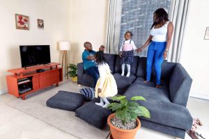 mom, dad and daughter playing together indoors